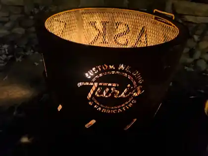 Turi's fabricated outdoor fire pit glowing at night